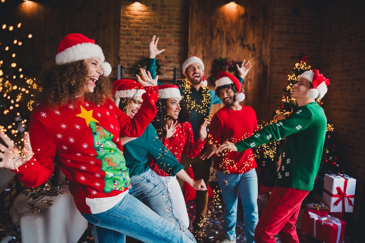 Cheerful young people friends group good mood dancing cozy Christmas party decor