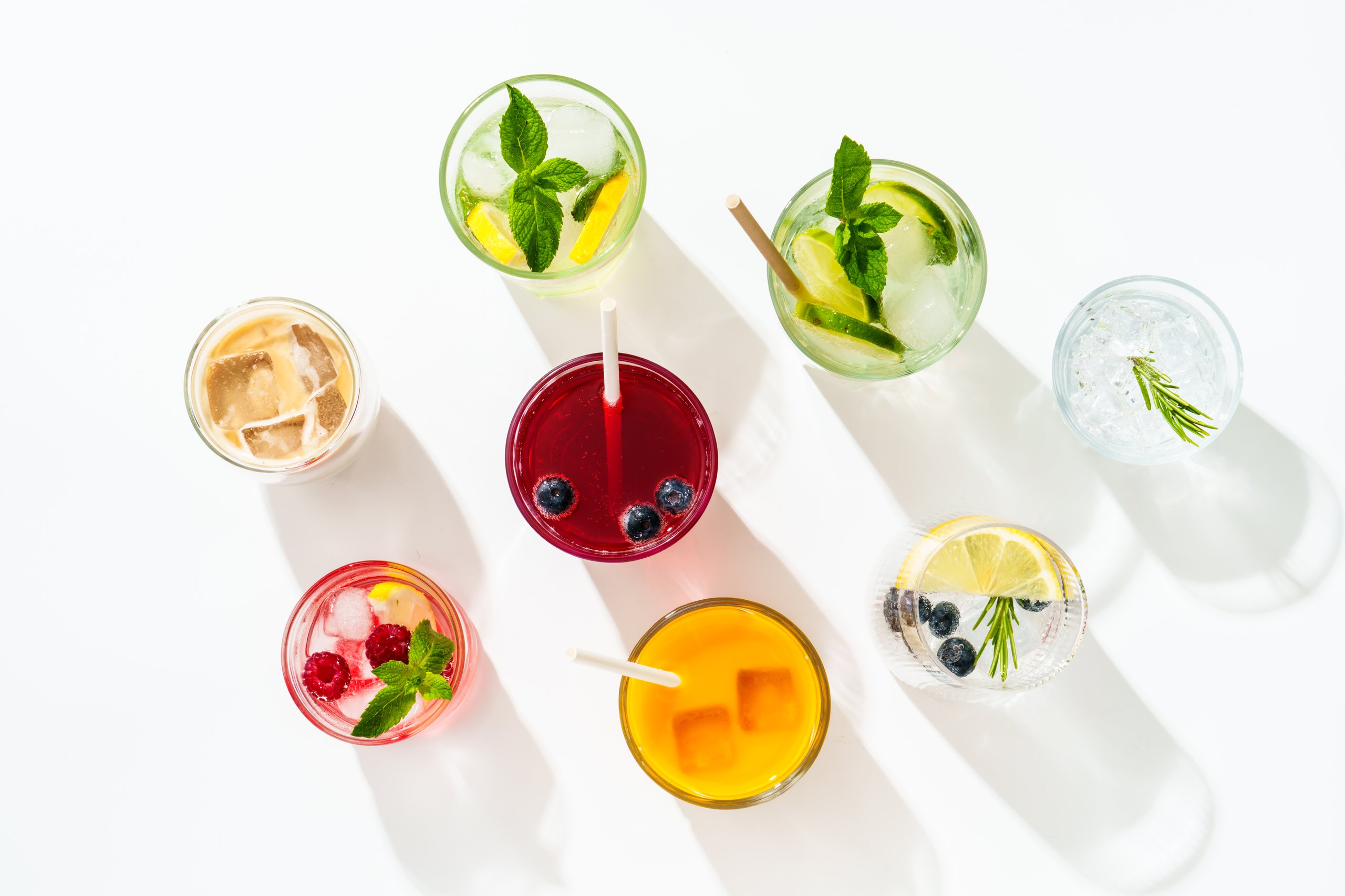 Summer drinks, colored cocktails on white background - lemonade, mojito, raspberry lemonade