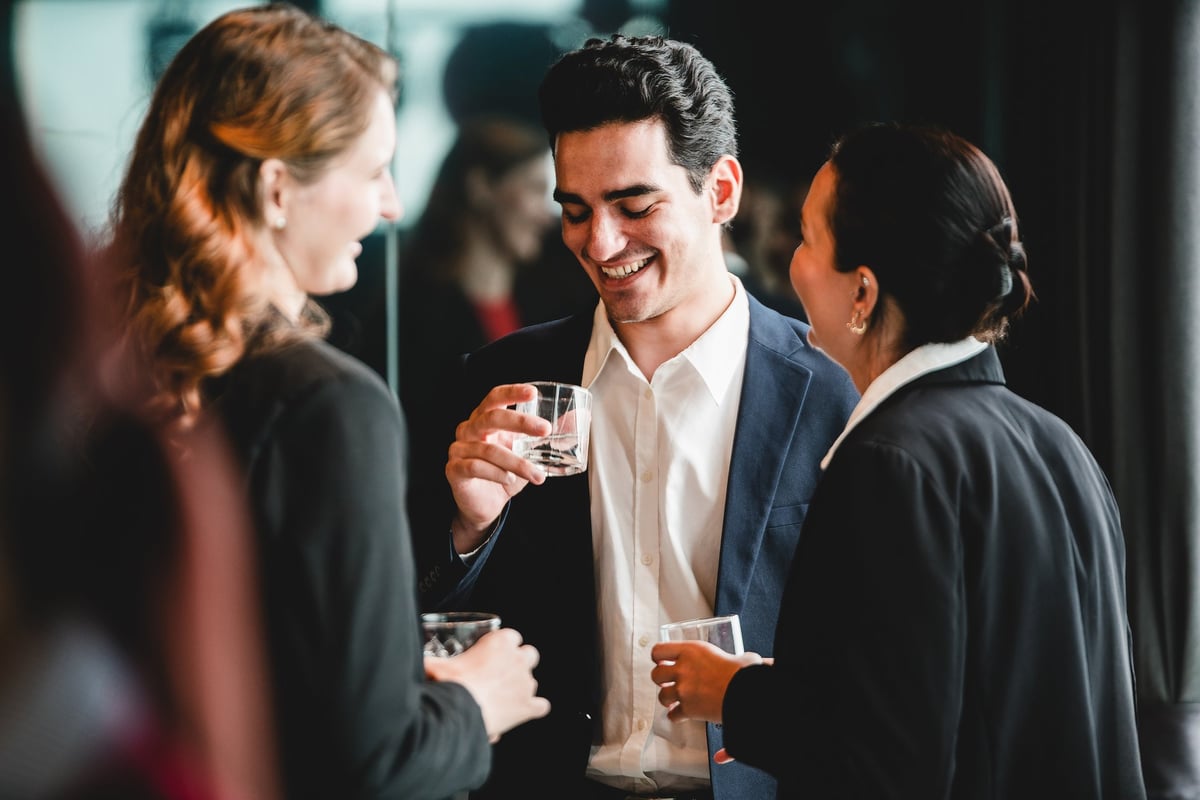 Business professionals gather after work for drinks, a relaxed office party moment