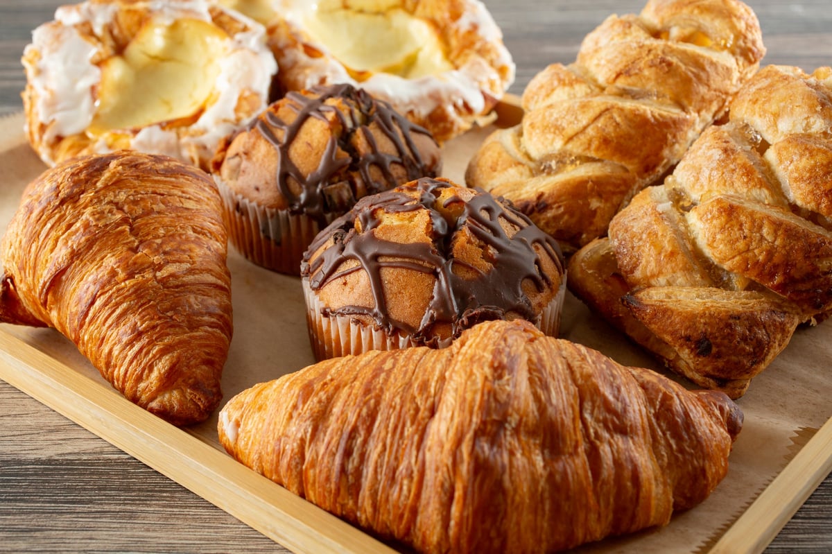 A view of a wood tray full of assorted pastries