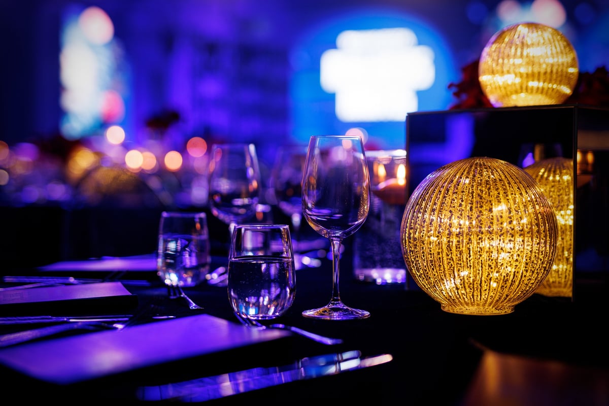 Formally set table for a gala dinner with glassware and polished cutlery
