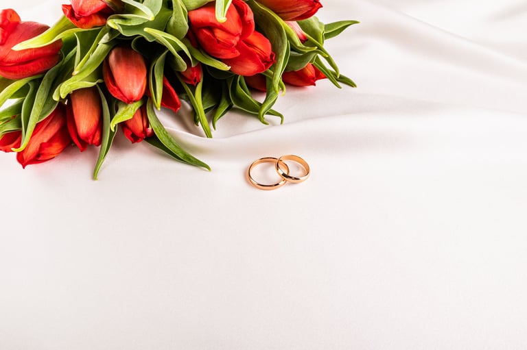 Wedding rings on satin with tulips