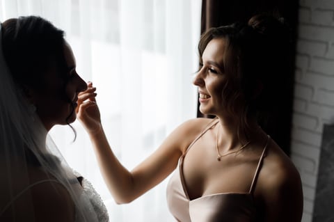 Bridesmaid fixing hair