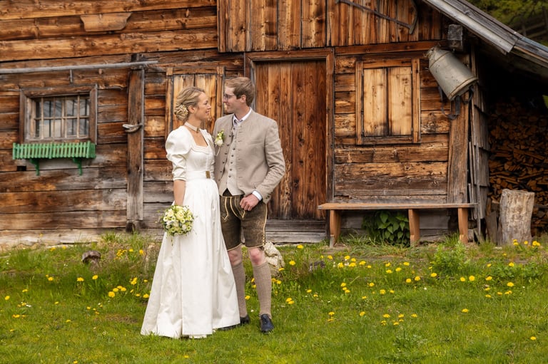 Couple holding hands in front of a rustic cabin