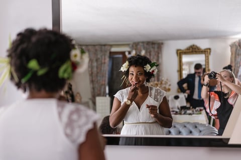 Bride applying lipstick